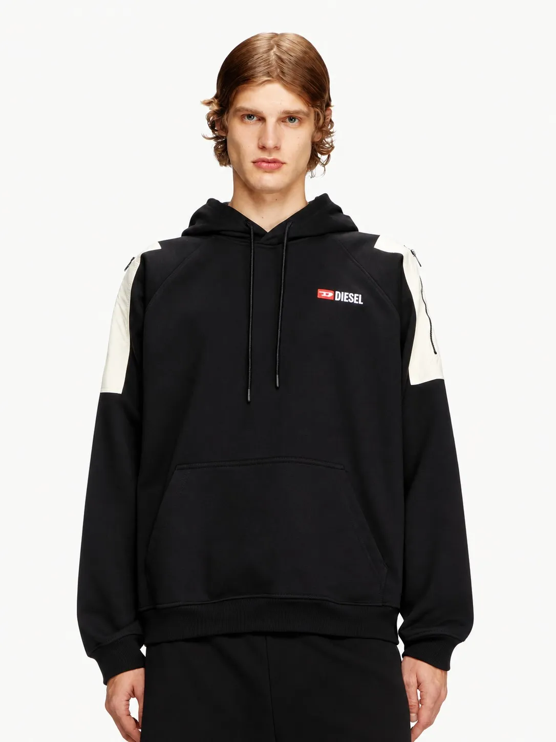 Hoodie Diesel negro puesto, plano medio de un modelo que lo lleva con pantalón negro